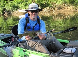Aaron Rubel with a smallmouth caught on a yellow popper fly. I was wearing Maui Jim Sunglasses in Wassup frames with rose toned lens.